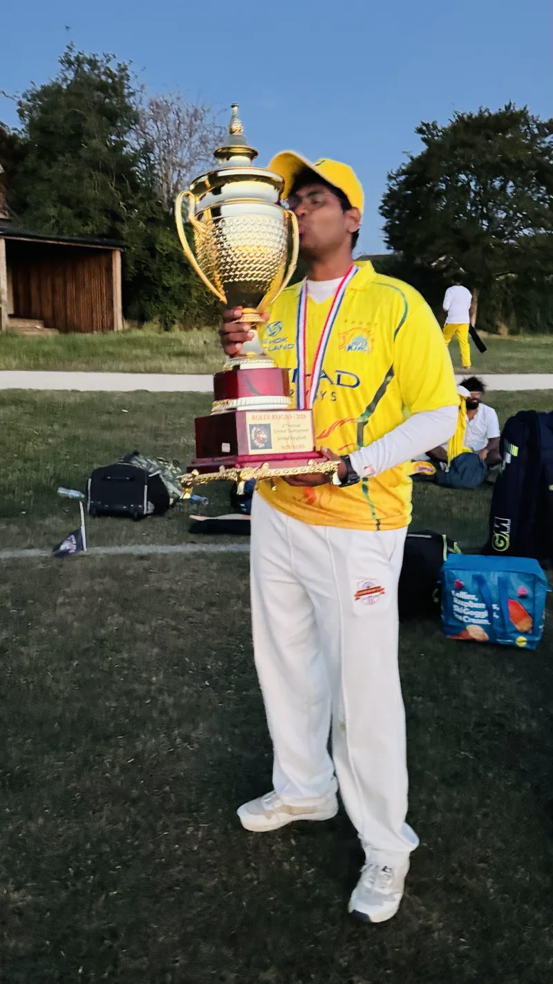 Ajay holding a cricket trophy