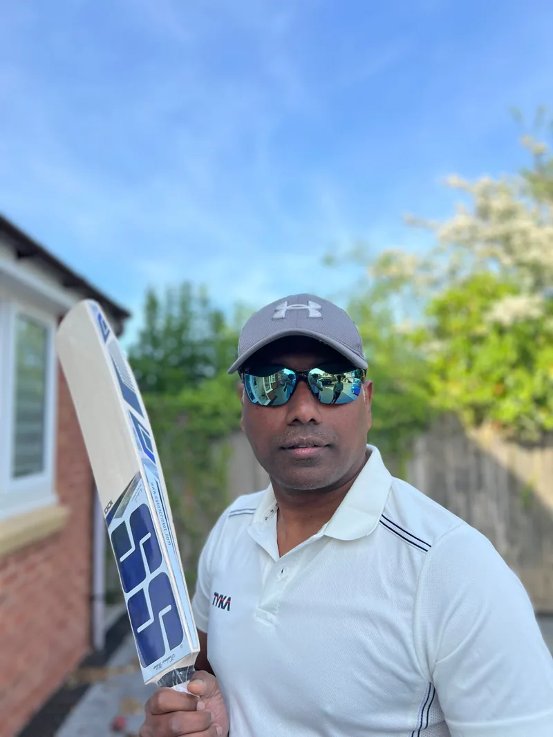 Alwin holding a cricket bat