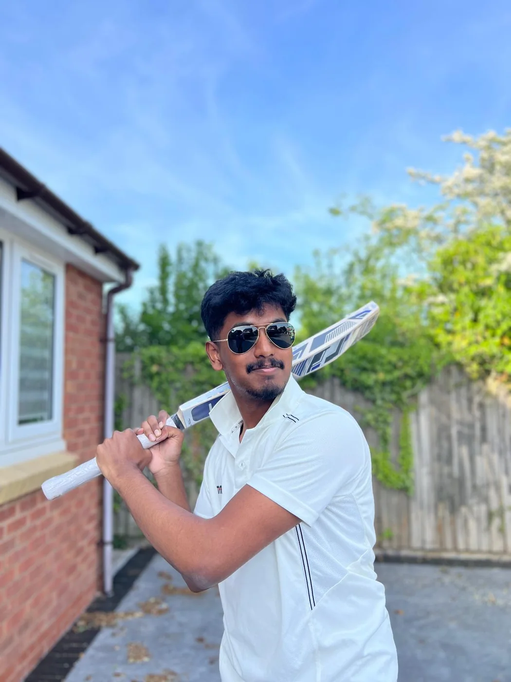 Ashwin holding a cricket bat