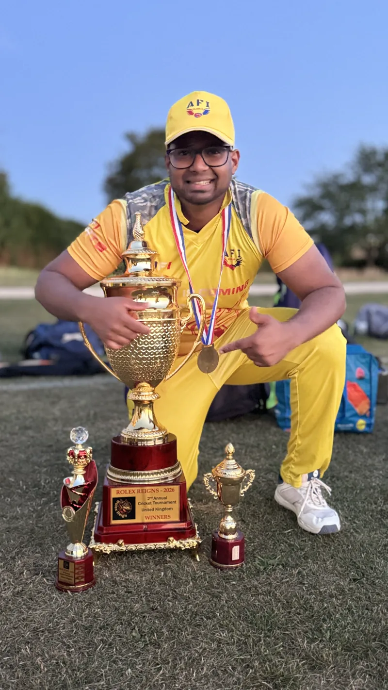 Gladiwin posing with cricket trophies