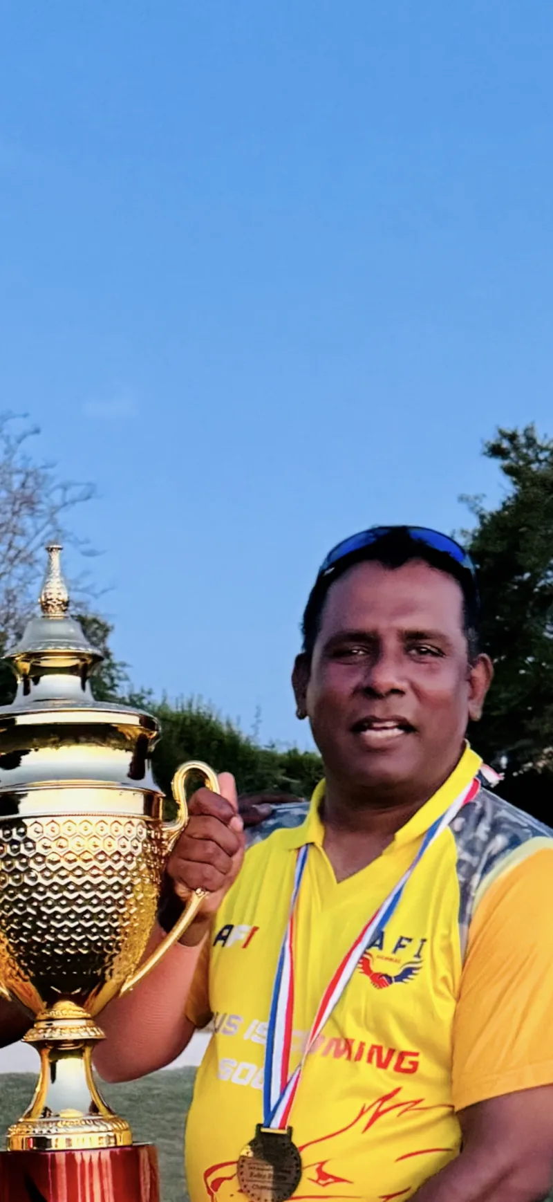 Jesu holding a cricket trophy
