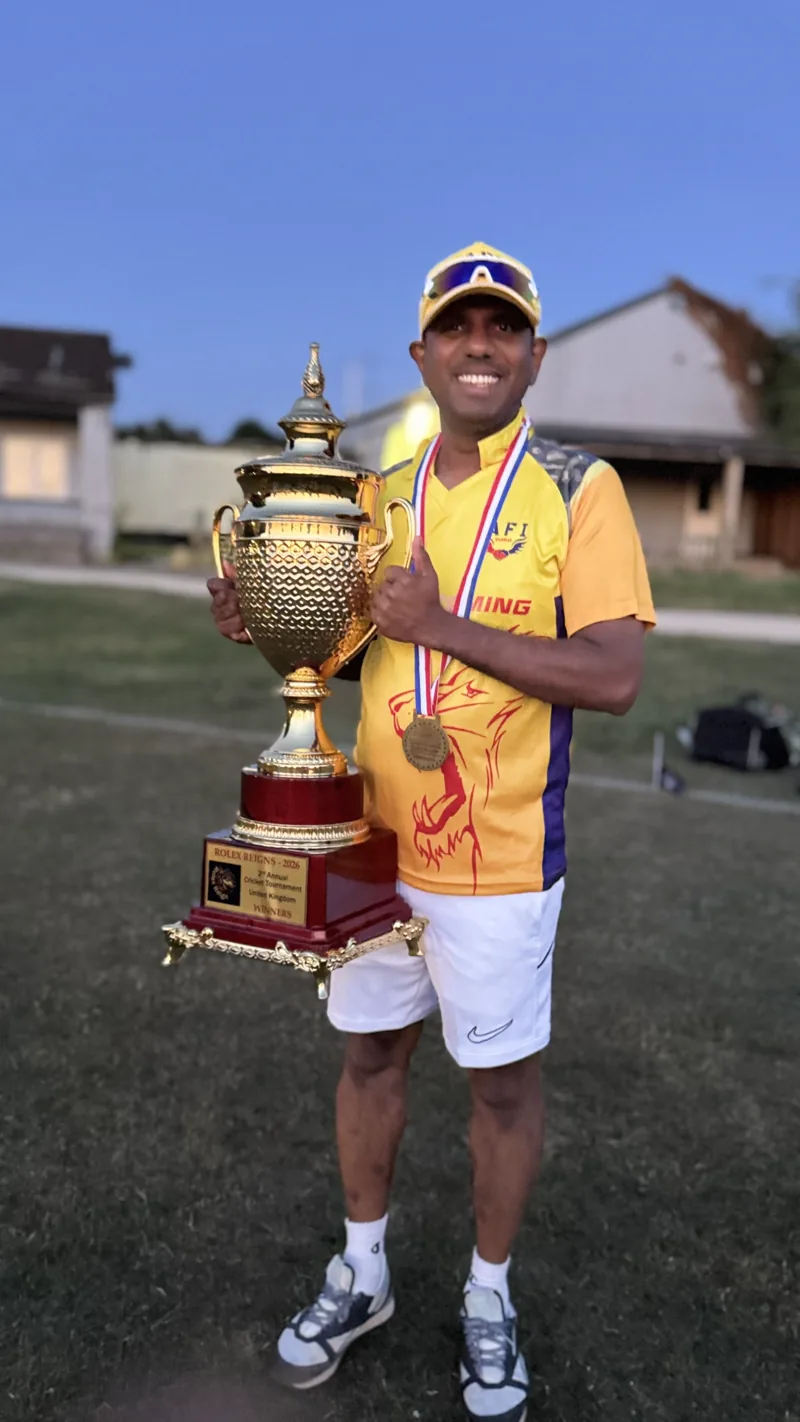 John Thomas holding a cricket trophy