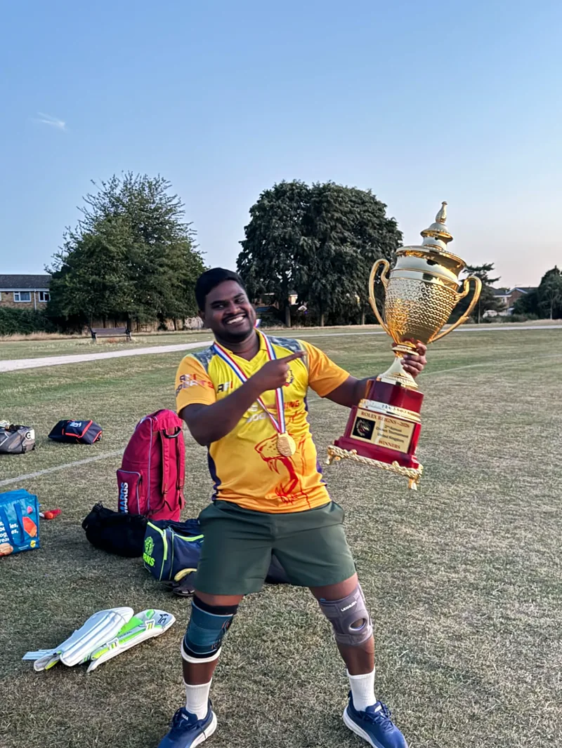 Sharon celebrating with a cricket trophy